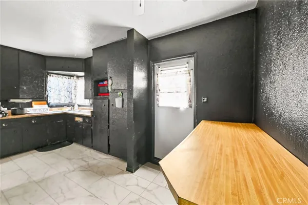 a kitchen with stainless steel appliances kitchen island a refrigerator sink and wooden floor