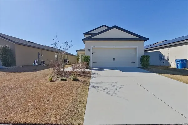 a view of a house with backyard and sitting area