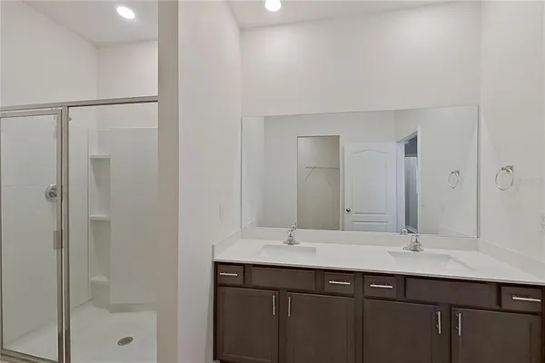 a bathroom with a glass shower door