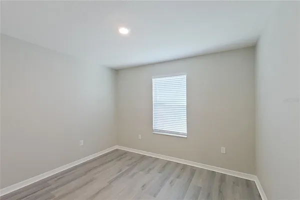 a view of an empty room and wooden floor