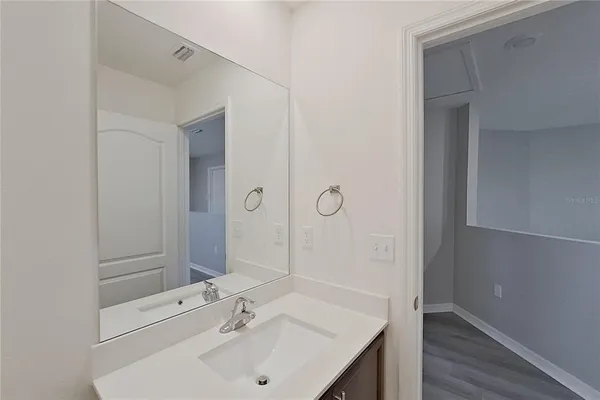 an empty room with wooden floor and window