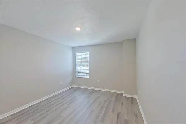 a view of room with wooden floor