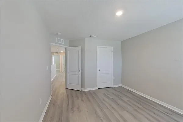 a view of a room with wooden floor and window