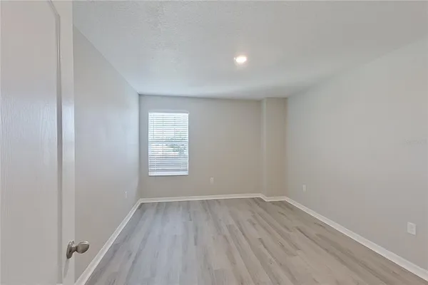 a view of an empty room and wooden floor