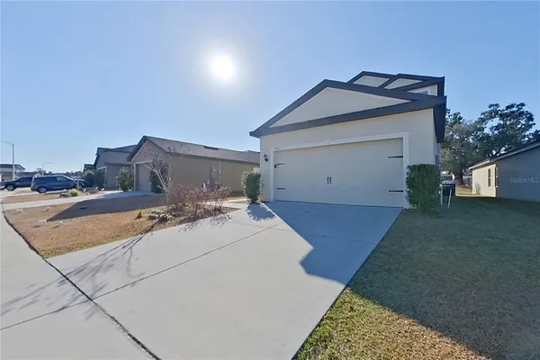 a kitchen with stainless steel appliances granite countertop a stove top oven a sink and a refrigerator