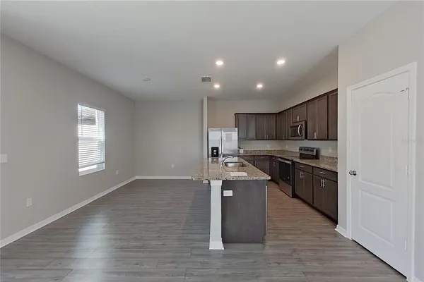 a view of kitchen with sink and wooden floor