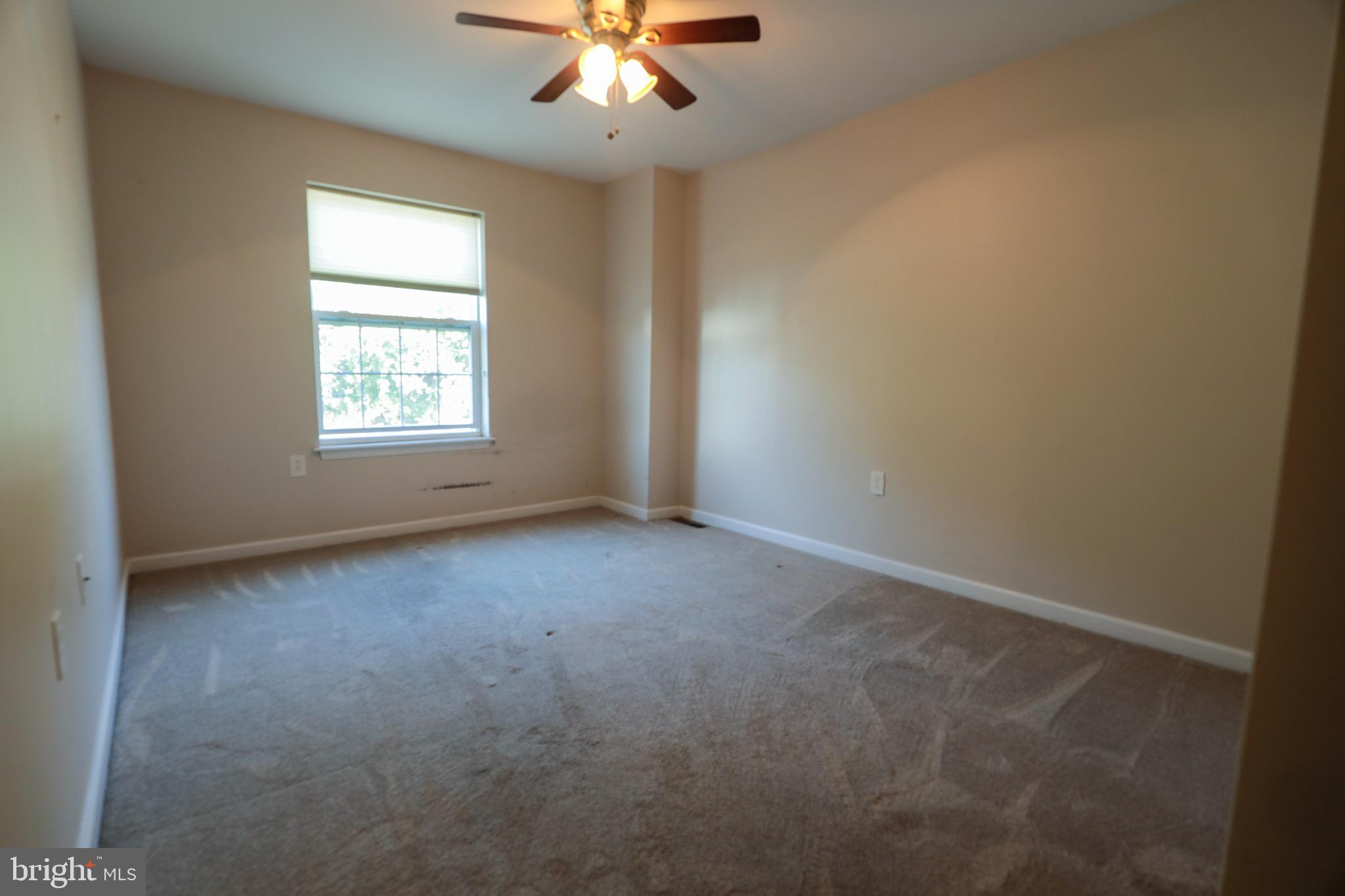 4779 Manayunk Avenue Philadelphia, PA 19128 - Photo 11 of 17 an empty room with a window and a fan