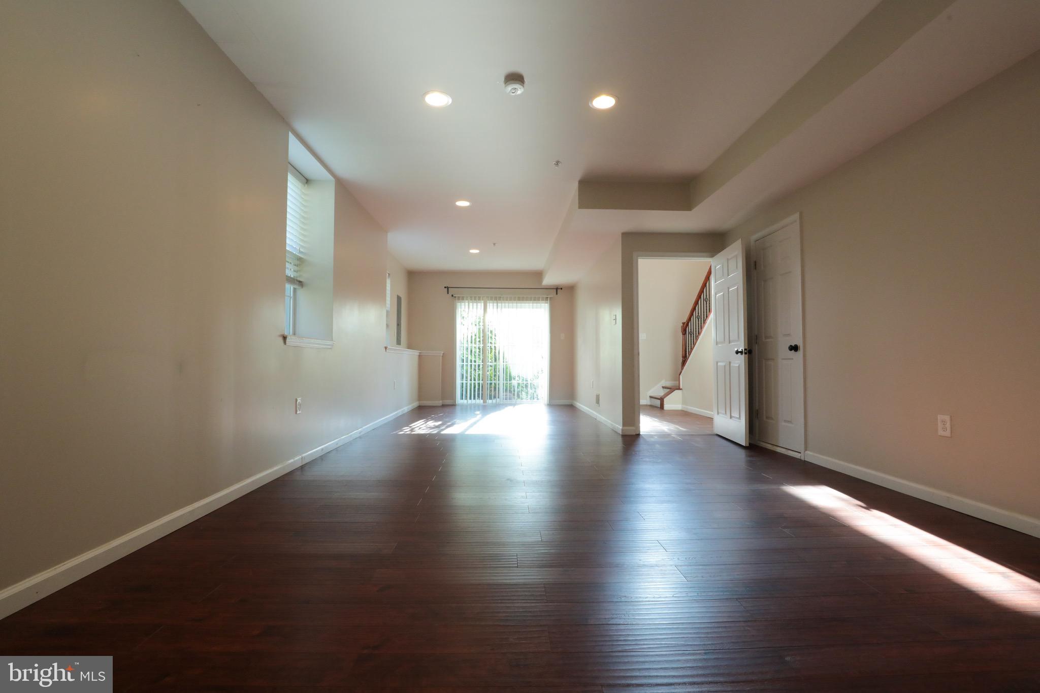 4779 Manayunk Avenue Philadelphia, PA 19128 - Photo 16 of 17 an empty room with wooden floor and windows