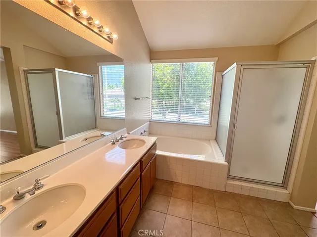 a bathroom with a tub sink and mirror