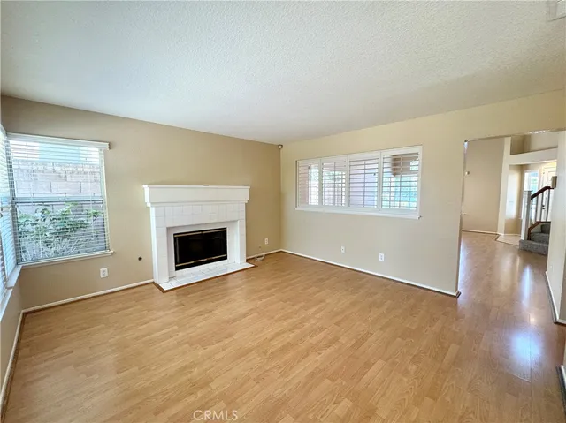 wooden floor fireplace and natural light in room
