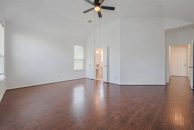 a view of a room with wooden floor and white walls