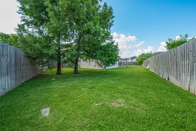 a view of a house with a yard and sitting area