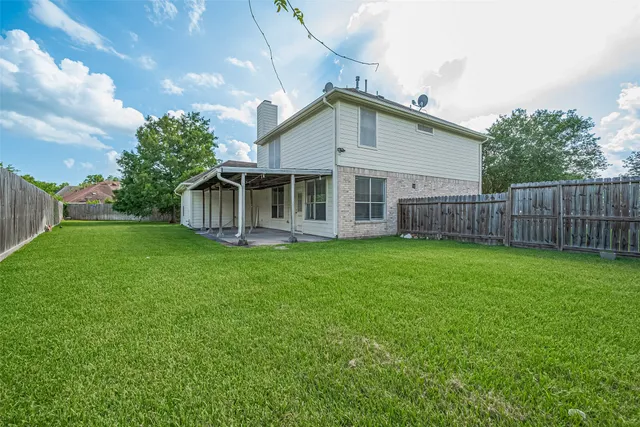 a view of a house with a backyard