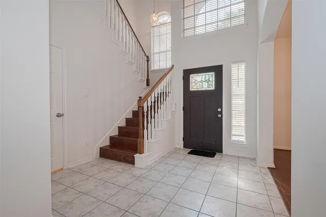 an empty room with windows and fireplace