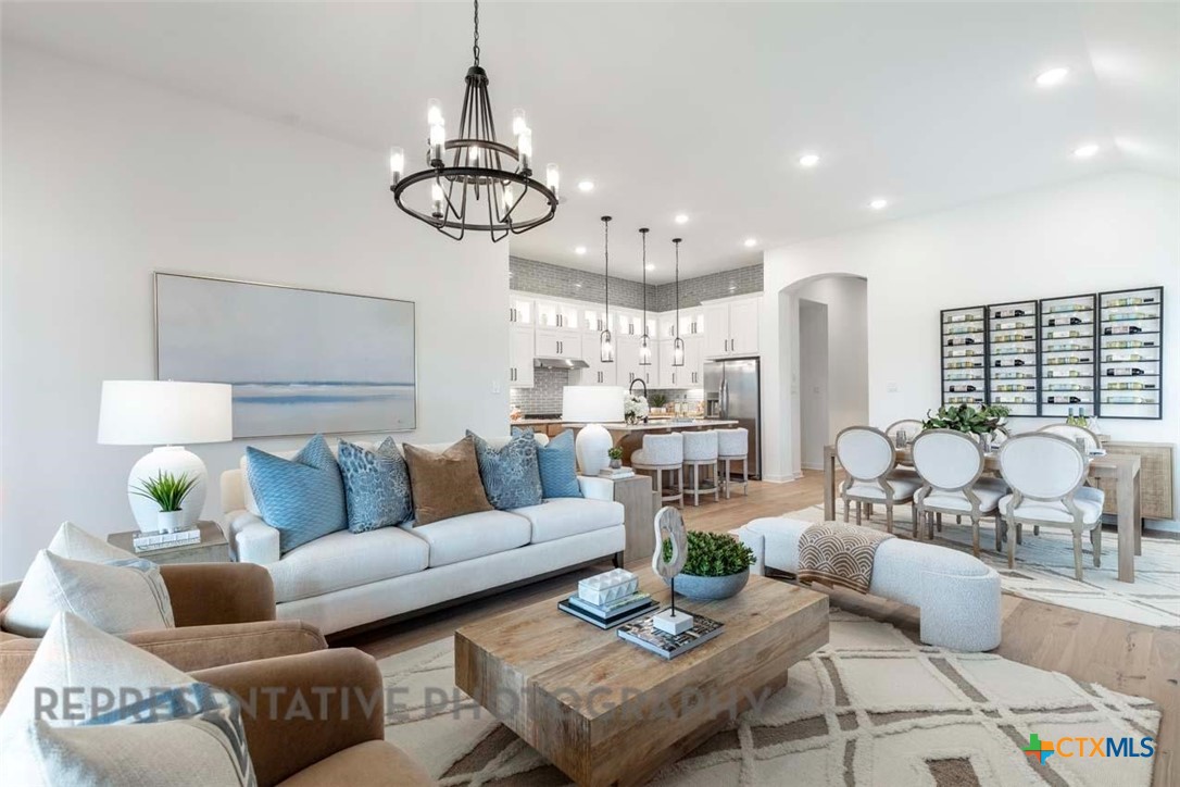 508 High Summit Drive Georgetown, TX 78628 - Photo 17 of 39 a living room with furniture kitchen view and a chandelier