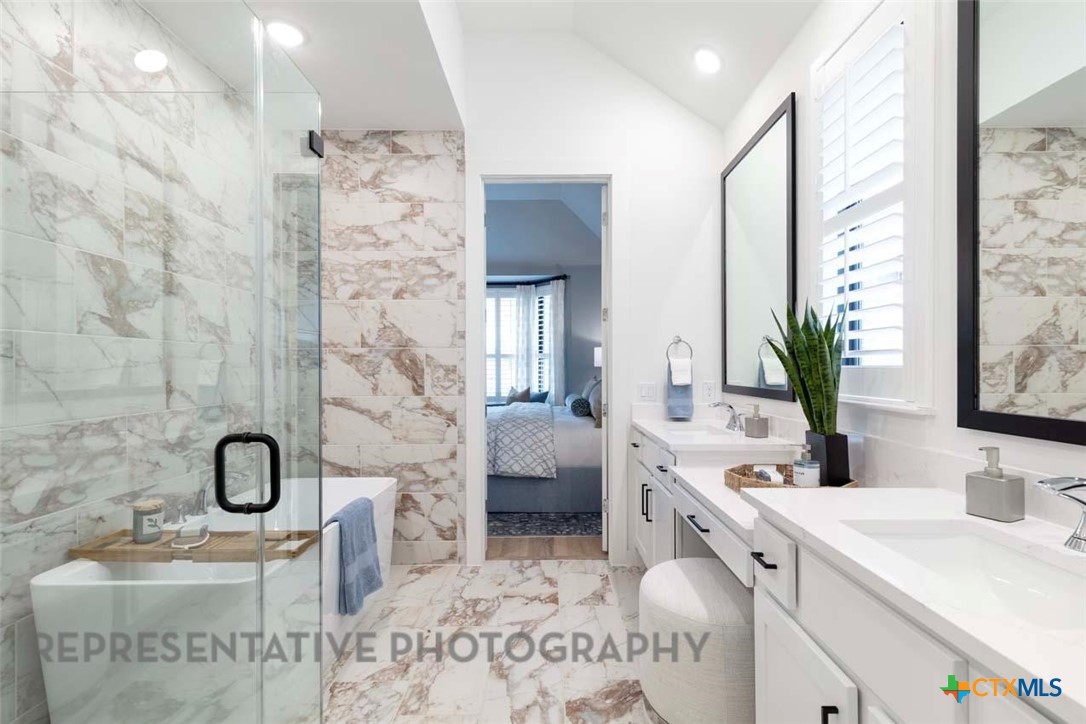508 High Summit Drive Georgetown, TX 78628 - Photo 22 of 39 a bathroom with a double vanity sink mirror and shower