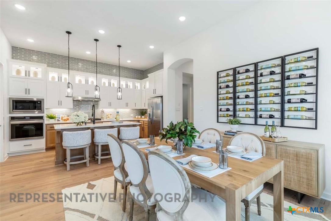 508 High Summit Drive Georgetown, TX 78628 - Photo 33 of 39 a kitchen with kitchen island granite countertop a sink and cabinets