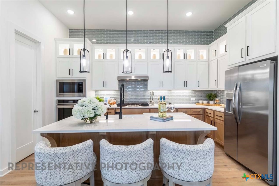 508 High Summit Drive Georgetown, TX 78628 - Photo 4 of 39 a kitchen with granite countertop lots of white stainless steel appliances