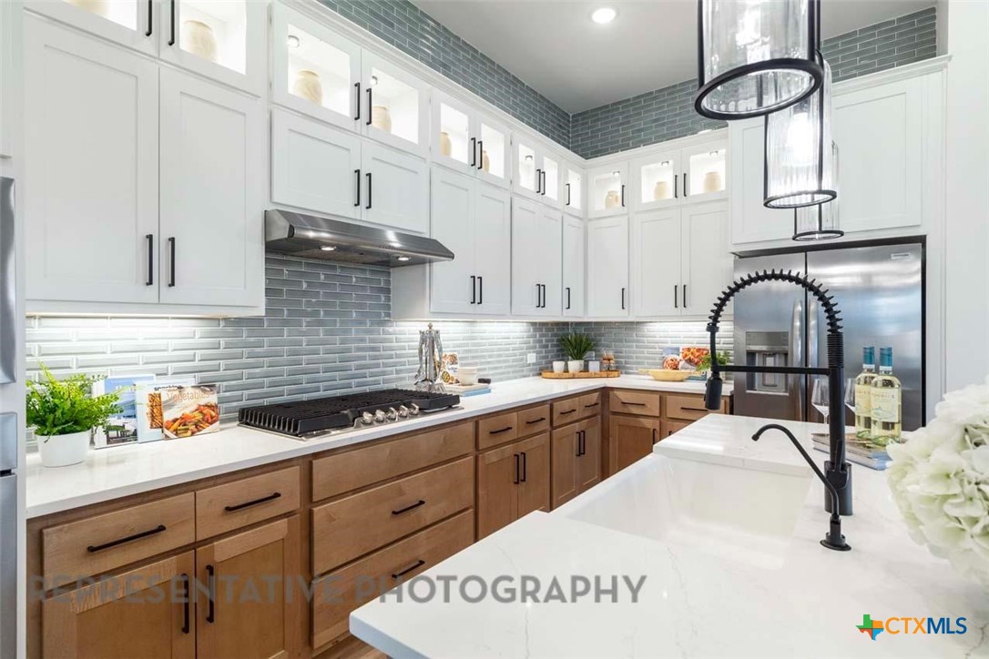 508 High Summit Drive Georgetown, TX 78628 - Photo 5 of 39 a kitchen with stainless steel appliances granite countertop a sink a stove and cabinets