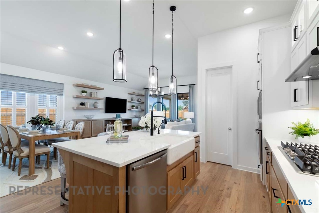 508 High Summit Drive Georgetown, TX 78628 - Photo 9 of 39 a kitchen with a sink a counter top space stainless steel appliances and a center island