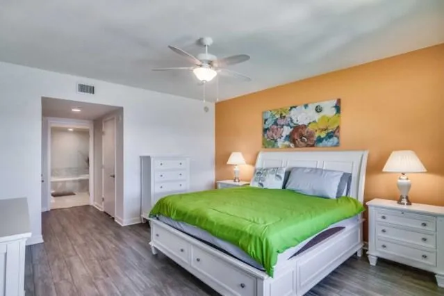 a bedroom with a bed and a wall painting