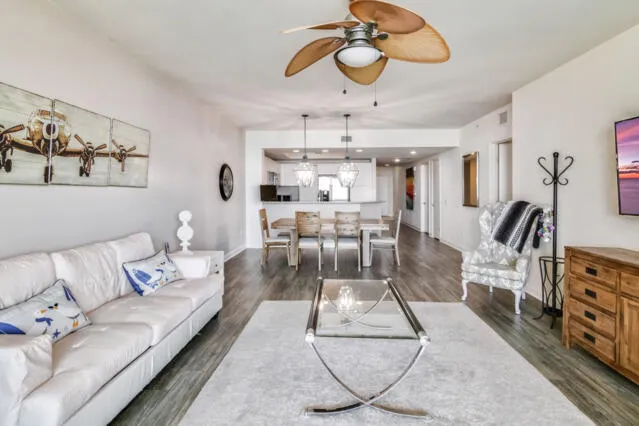 a living room with furniture and a chandelier
