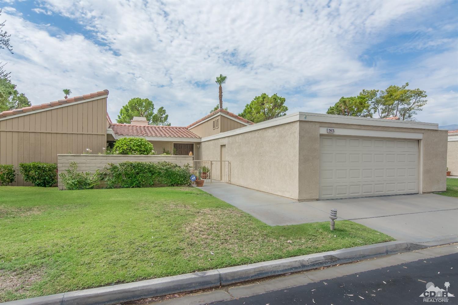 72475 Rodeo Way, Unit 320 Rancho Mirage, CA 92270 - Photo 1 of 26 a front view of a house with garden