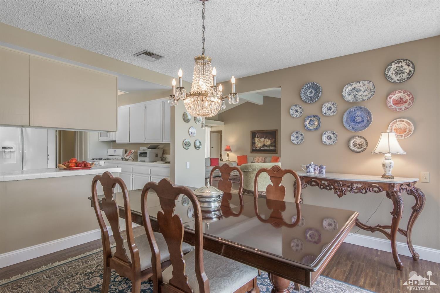 72475 Rodeo Way, Unit 320 Rancho Mirage, CA 92270 - Photo 7 of 26 a view of a dining room with furniture and chandelier