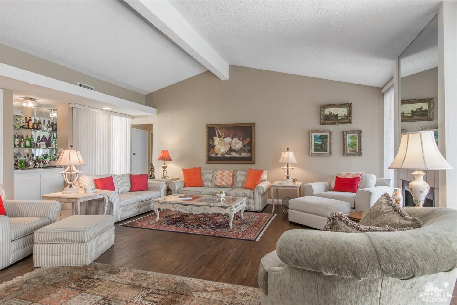72475 Rodeo Way, Unit 320 Rancho Mirage, CA 92270 - Photo 8 of 26 a living room with furniture and a large window