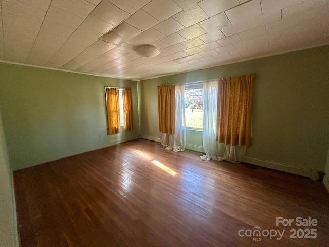 325 Sheldon Street Hudson, NC 28638 - Photo 11 of 33 an empty room with wooden floor and windows