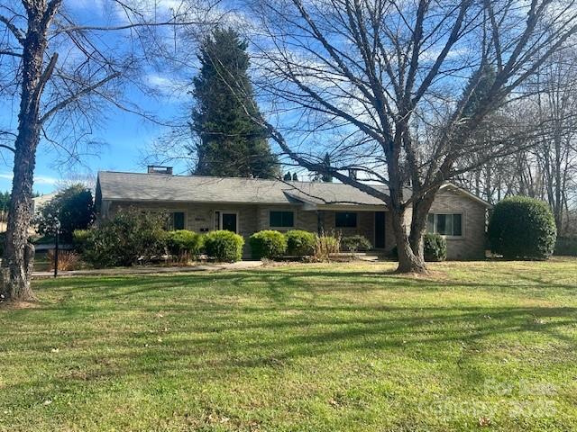 325 Sheldon Street Hudson, NC 28638 - Photo 2 of 33 a front view of a house with a garden