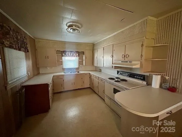 a kitchen with a stove a sink and a refrigerator