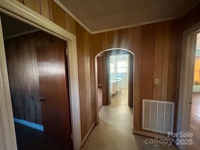 a view of a hallway with wooden walls