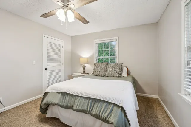 a bedroom with a bed and window
