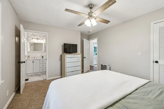 a bedroom with a large bed and a tv