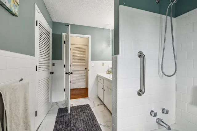 a bathroom with a shower and a sink