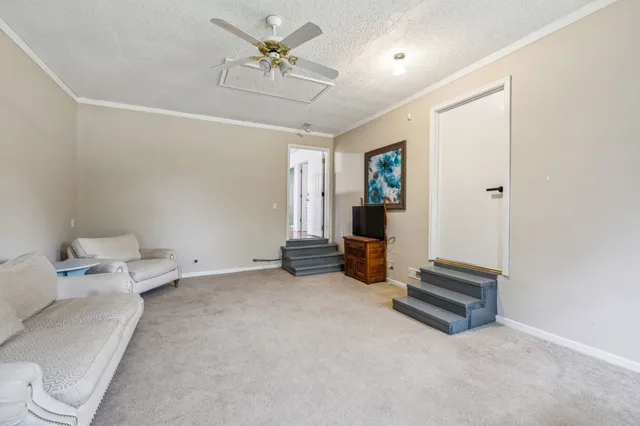 a view of room with couch and a ceiling fan