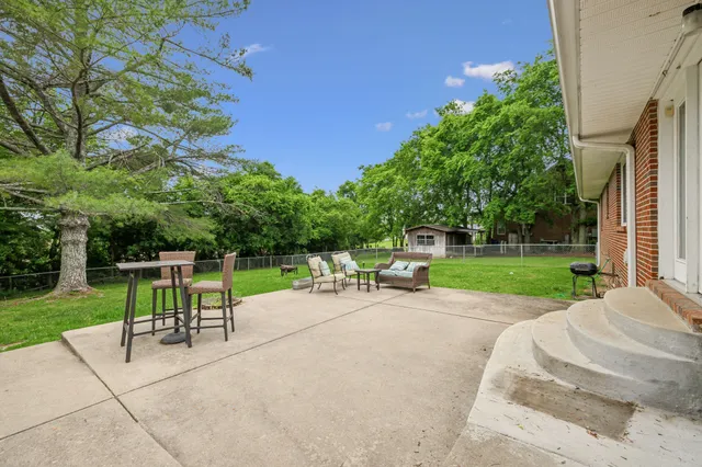 a view of a backyard with sitting area