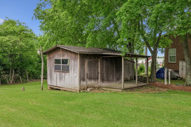 a backyard of a house with table and chairs