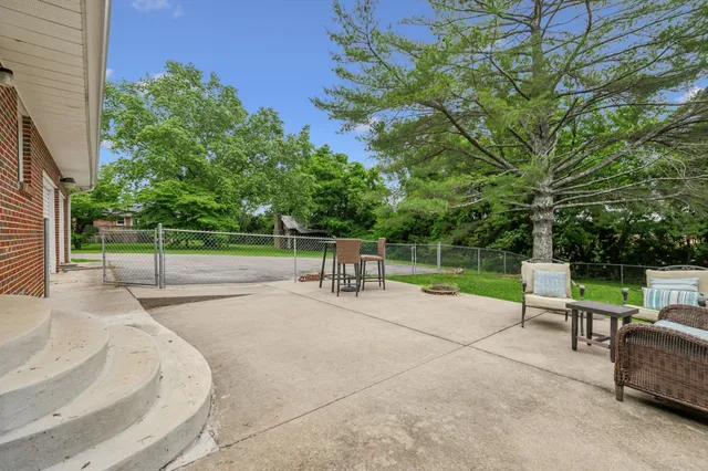 a view of backyard with seating area and green space