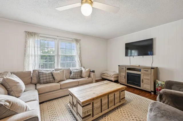 a living room with furniture and a flat screen tv