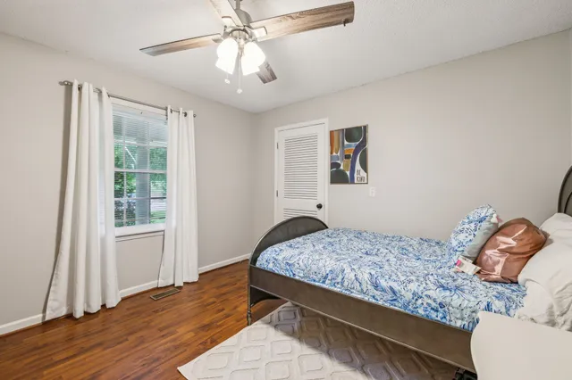 a bedroom with a large bed and a window