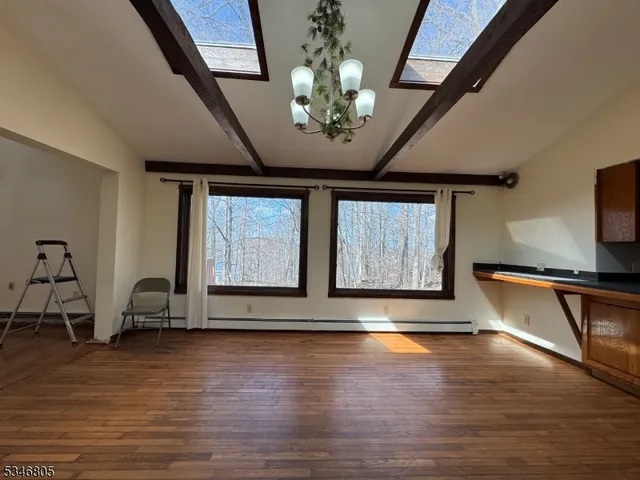 a view of an entryway with wooden floor