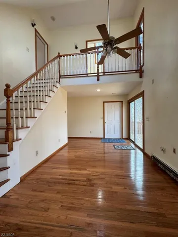 a view of entryway and hall with wooden floor