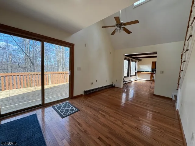 a view of wooden floor and a rug in a room
