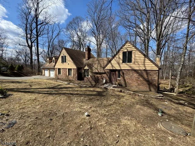 a view of house with snow on the road