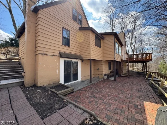 a backyard of a house with barbeque oven and bench