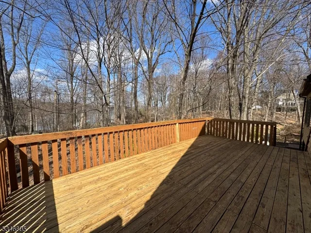 a view of balcony with wooden floor and fence
