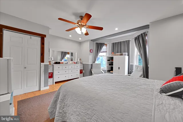 a bedroom with a large bed and a chandelier