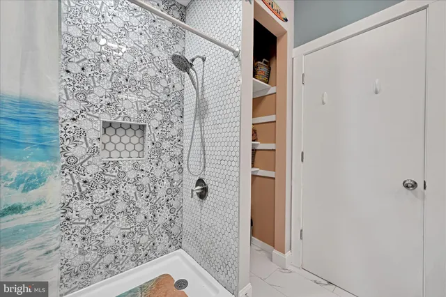 a bathroom with a shower and a sink